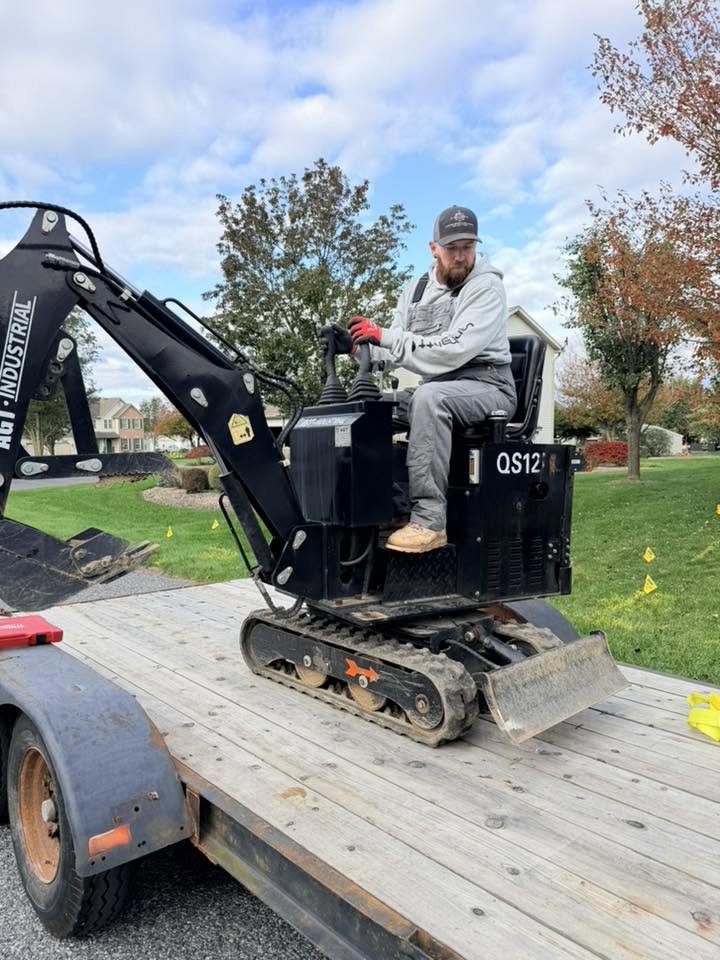Excavator operator performing precision grading on a site preparation job