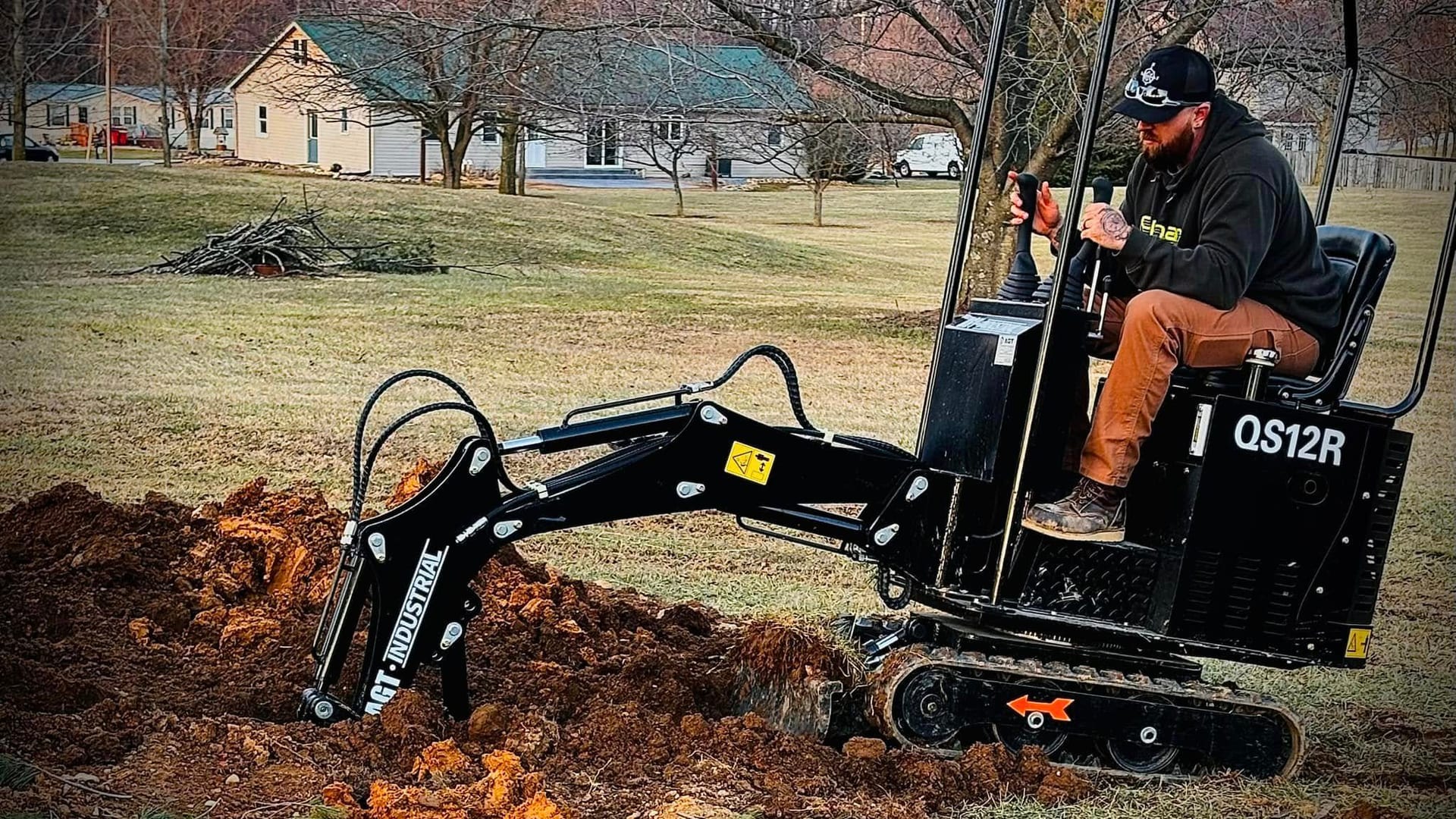 TNT Excavating Solutions excavator working on a site preparation project